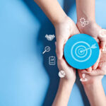 Business hands holding target icon, dartboard and arrow for creative and set up business objective target goal, marketing solution, target for business investment.